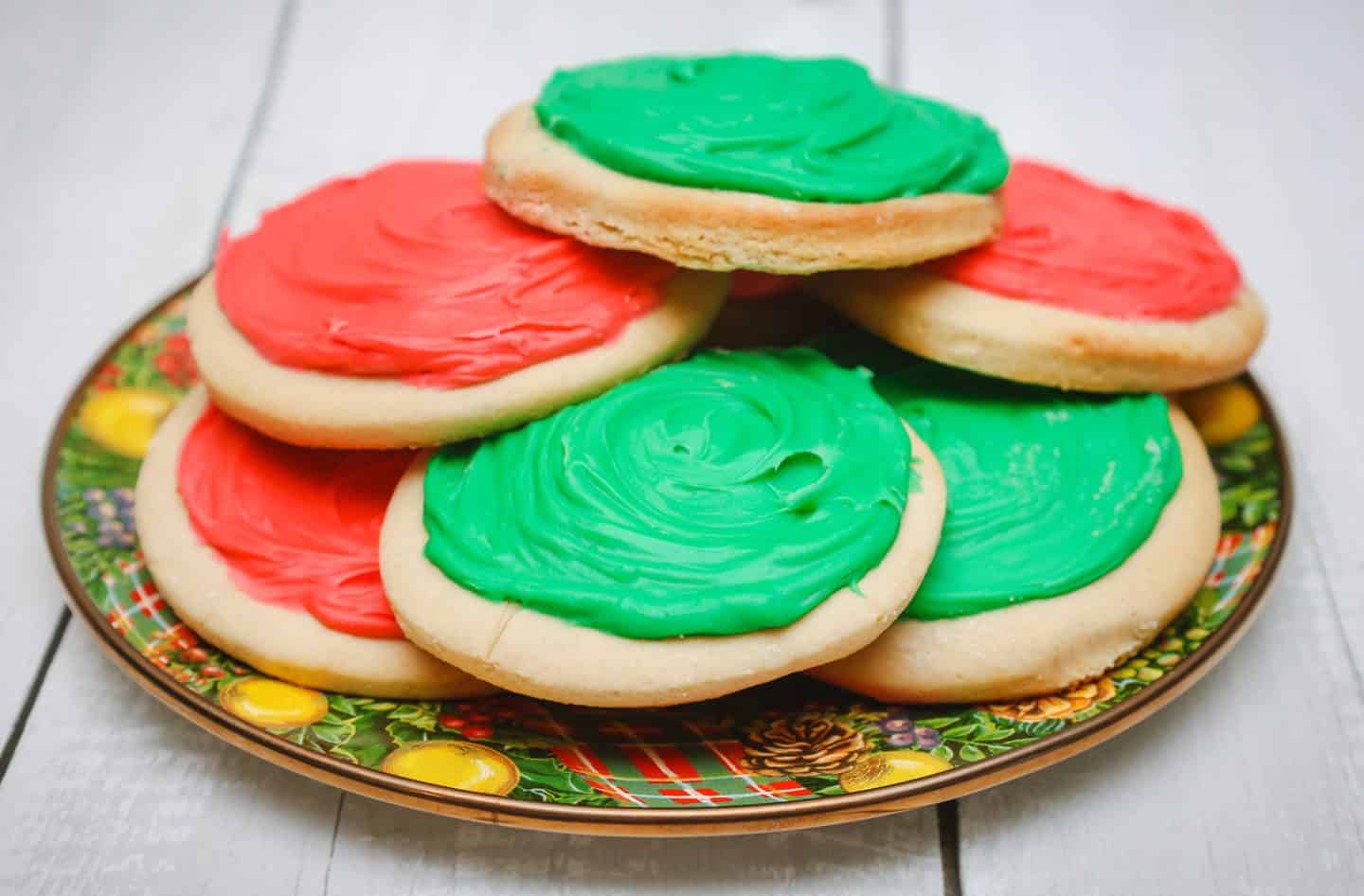Southern Soul Food Traditional Tea Cakes With Icing - A festive plate of Southern soul food tea cakes with red and green icing, stacked and ready for Christmas celebrations. A Black folks’ holiday dessert tradition, homemade and full of legacy "flava." Recipe by Shaunda Necole & The Soul Food Pot®.
