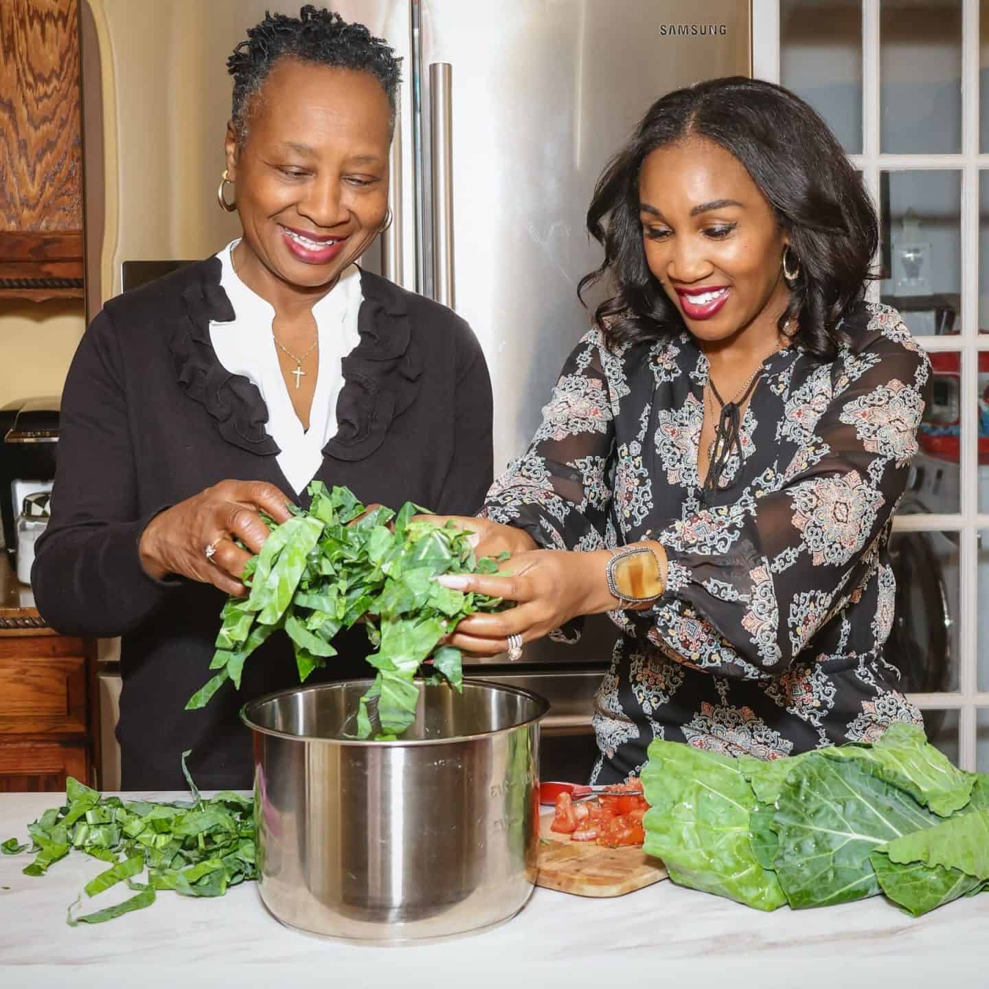 Shaunda Necole and her mother preparing Southern collard greens together in the kitchen, honoring Black History, African American culinary heritage, and generational soul food traditions at The Soul Food Pot&reg;.