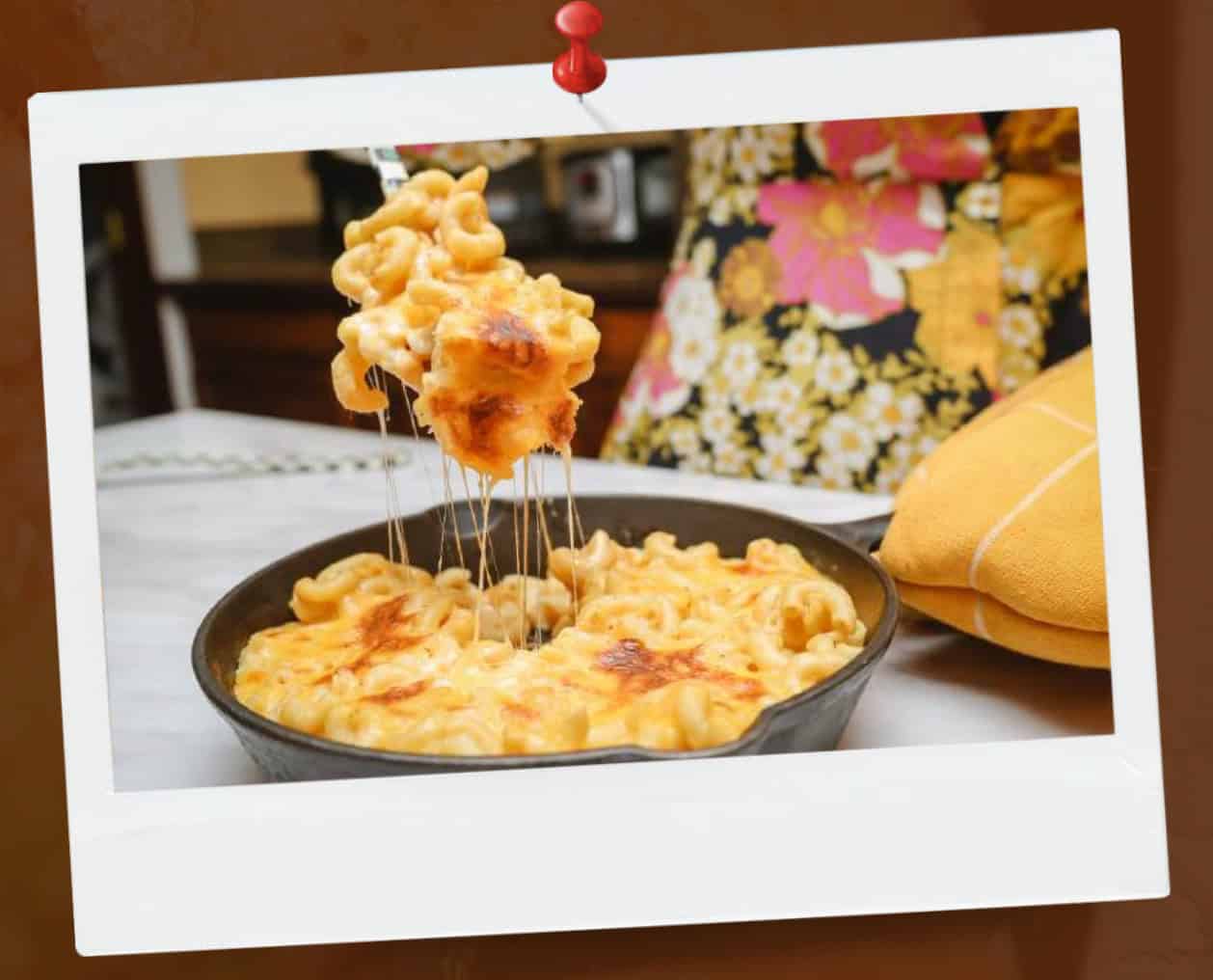 Baked macaroni and cheese with golden, bubbly burnt edges, a signature soul food classic featured in The Soul Food Pot Cookbook by Shaunda Necole.