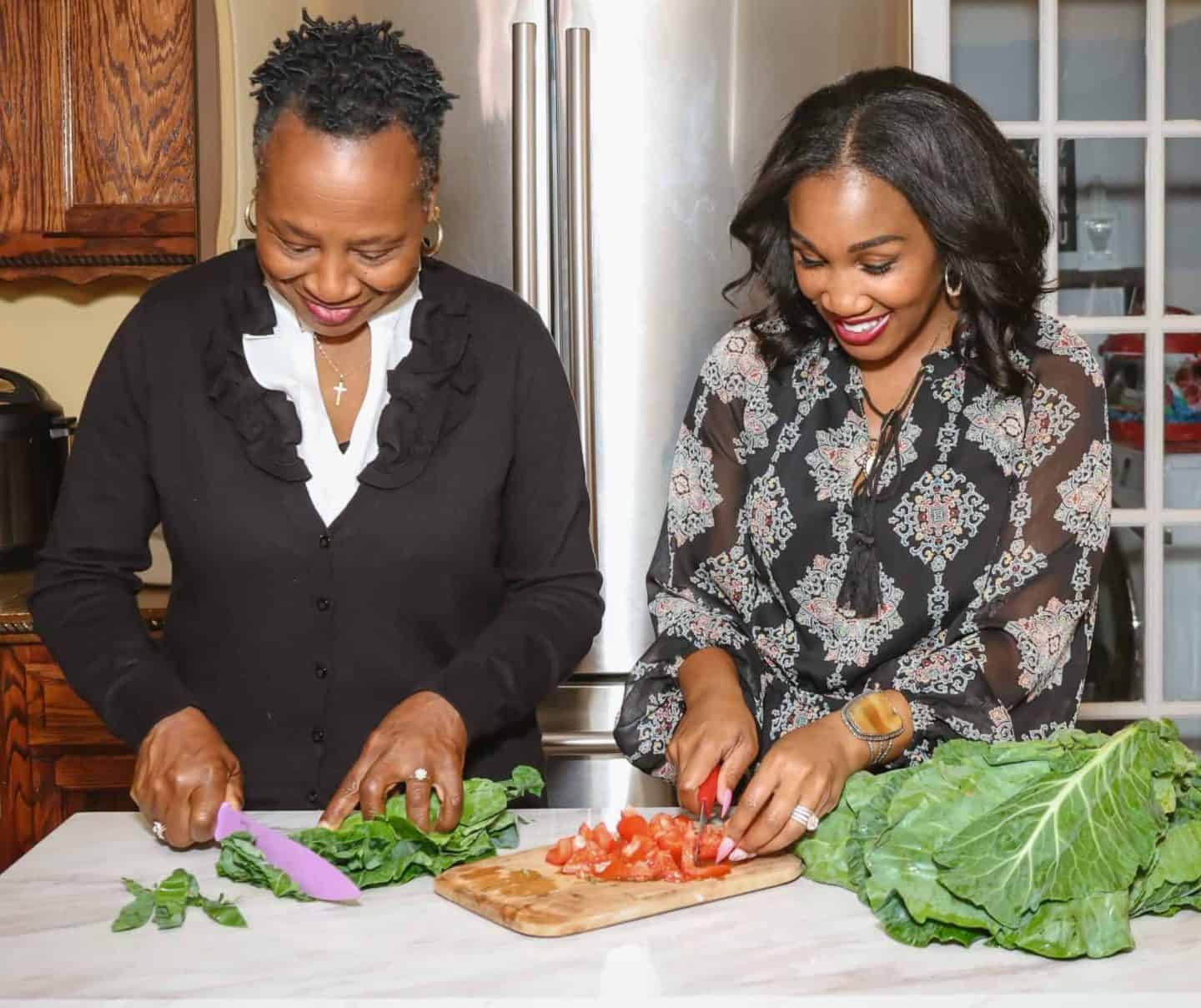 Shaunda Necole and Mama preparing fresh collard greens from scratch in the kitchen — a generational Soul Food Sunday dinner tradition by The Soul Food Pot®