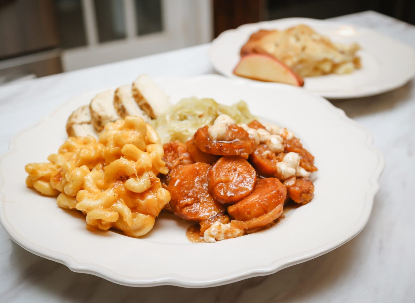 Classic Soul Food Sunday dinner plate featuring baked mac and cheese, candied yams, tender cabbage, and sliced roasted turkey — traditional Black family Sunday meal pairing ideas by The Soul Food Pot®