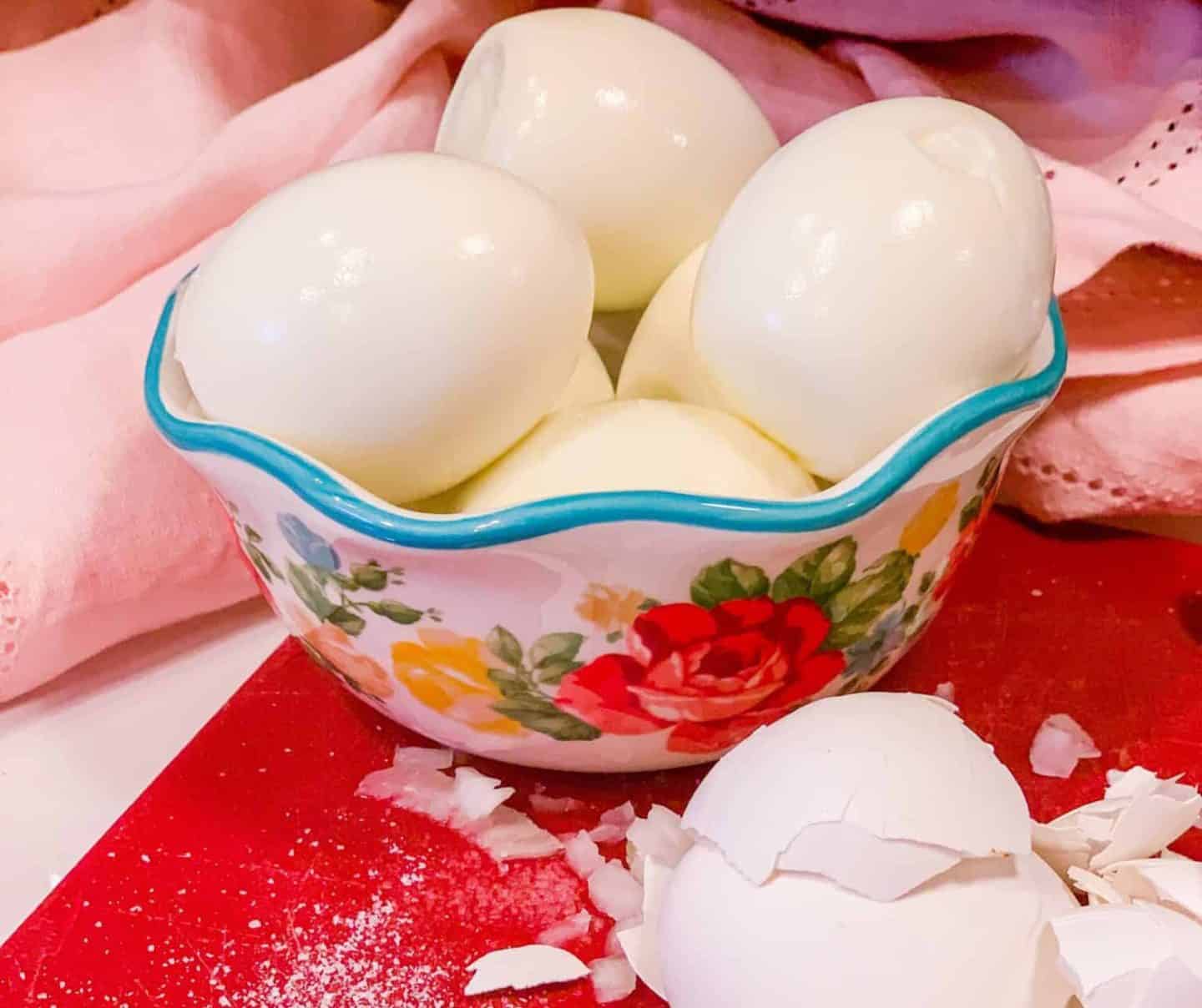 How to peel hard-boiled eggs for deviled eggs—smooth, clean eggs with shells removed on a cutting board, a key prep step in this Southern soul food recipe by The Soul Food Pot®