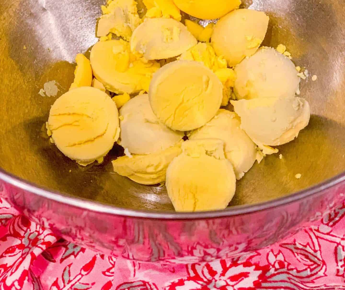 Cooked egg yolks in a mixing bowl ready to be mashed for deviled eggs filling, a classic step in Black folks’ soul food deviled eggs by The Soul Food Pot®