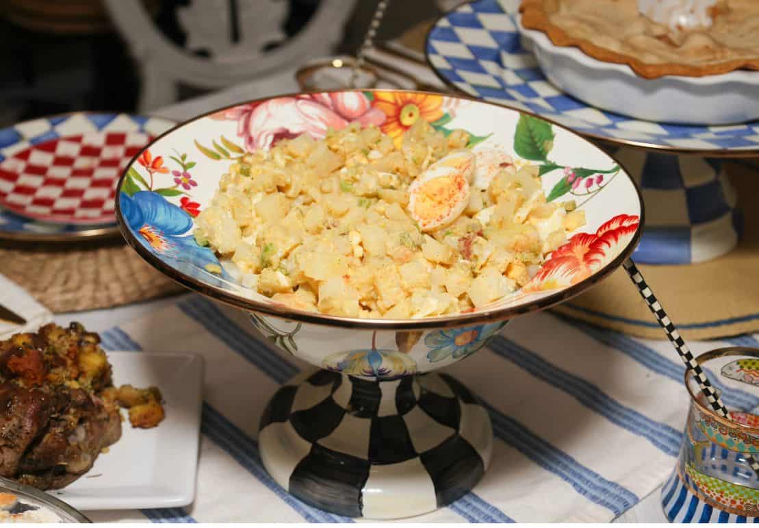 Black Folks potato salad with chopped eggs and paprika served in a floral pedestal bowl, Shaunda Necole’s featured Labor Day side dish from The Soul Food Pot®.