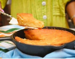 Cornbread slice lifted from the cast-iron skillet
