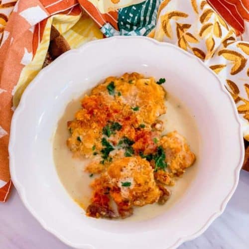 Finished smothered chicken in the white bowl