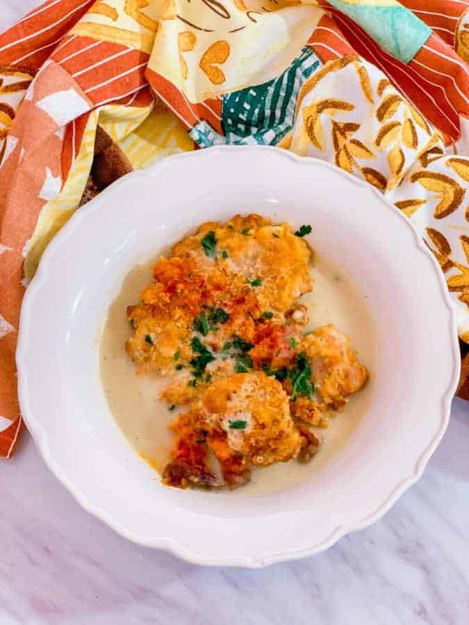 Finished smothered chicken in the white bowl