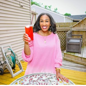 Holding red drink outdoors