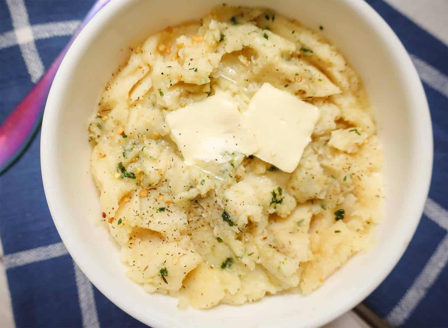 Creamy, fluffy mashed potatoes seasoned with herbs and garlic and topped with melting butter from The Soul Food Pot®.