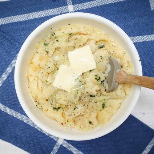 Mashed potatoes bowl with butter + spoon