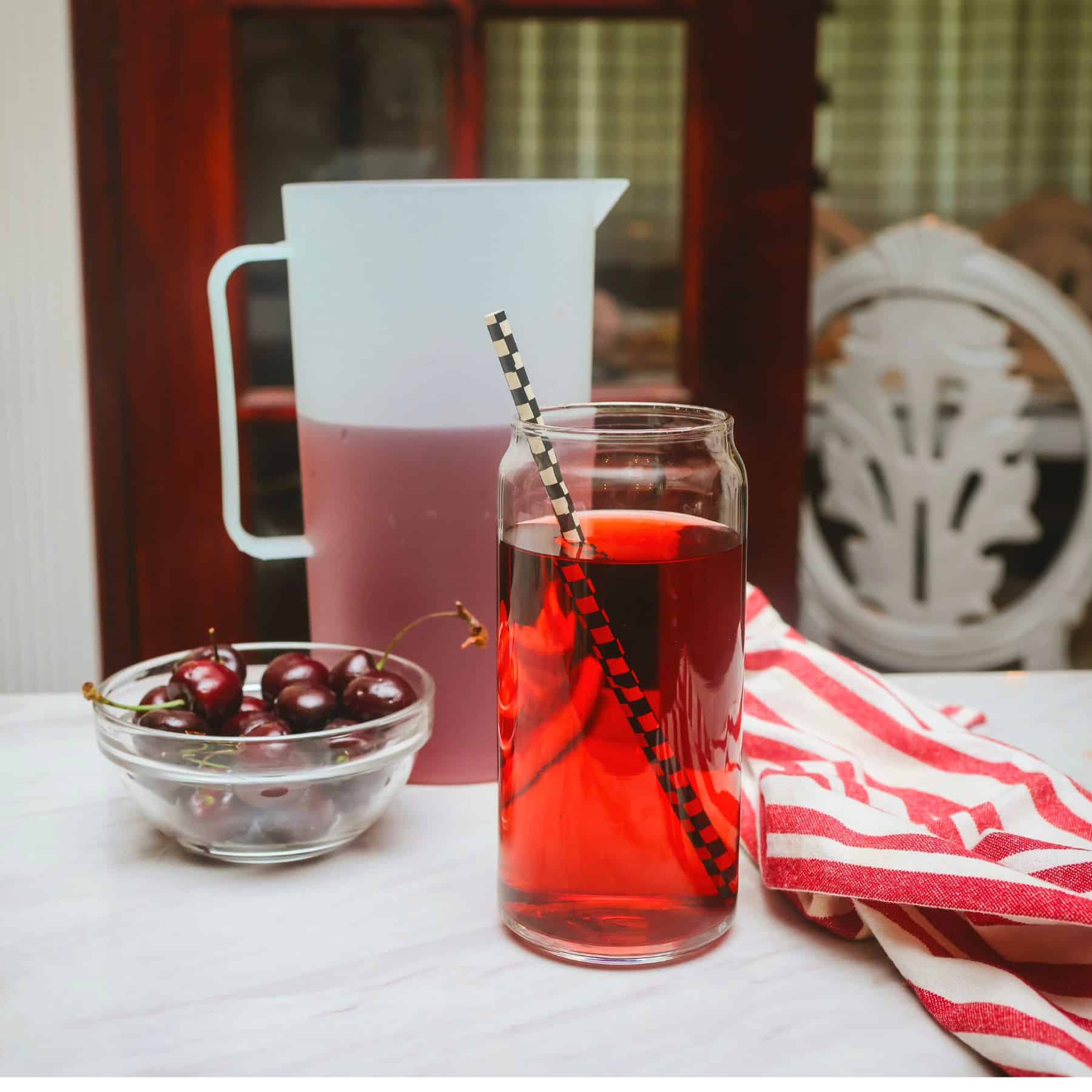 Red Kool-Aid glass, pitcher, and cherries