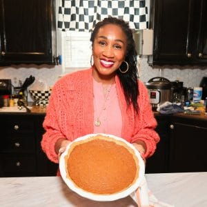Shaunda Necole holding the finished sweet potato pie