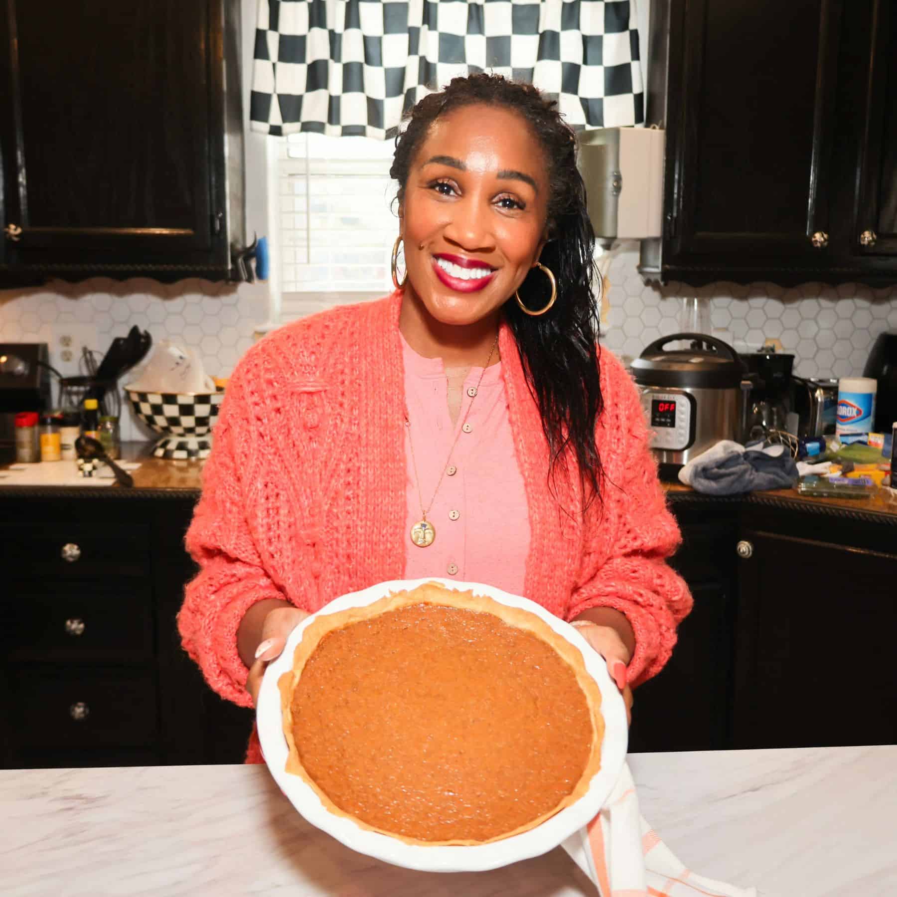 Shaunda Necole holding the finished sweet potato pie