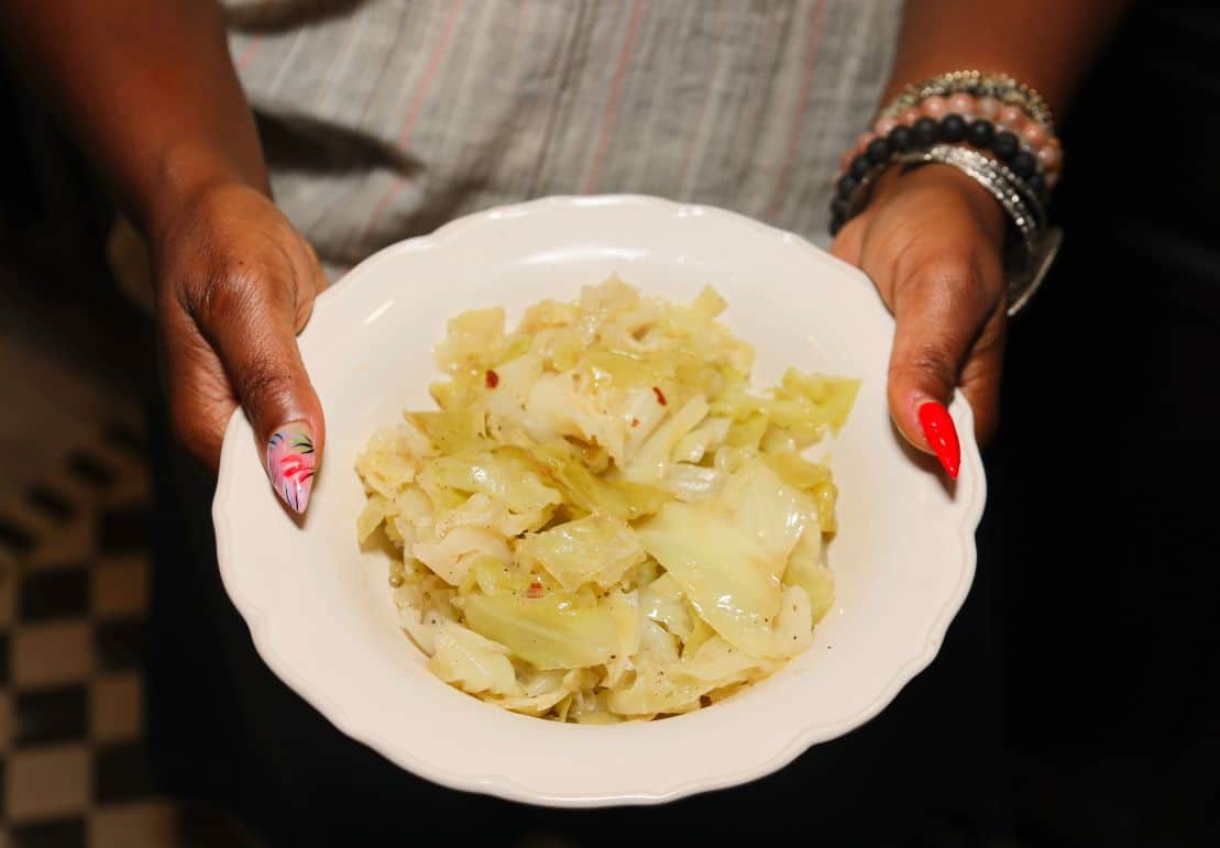 Shaunda Necole holds a bowl of tender Southern cabbage