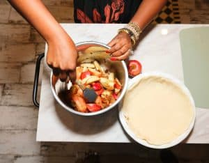 Shaunda preparing the apples beside the prepared crust