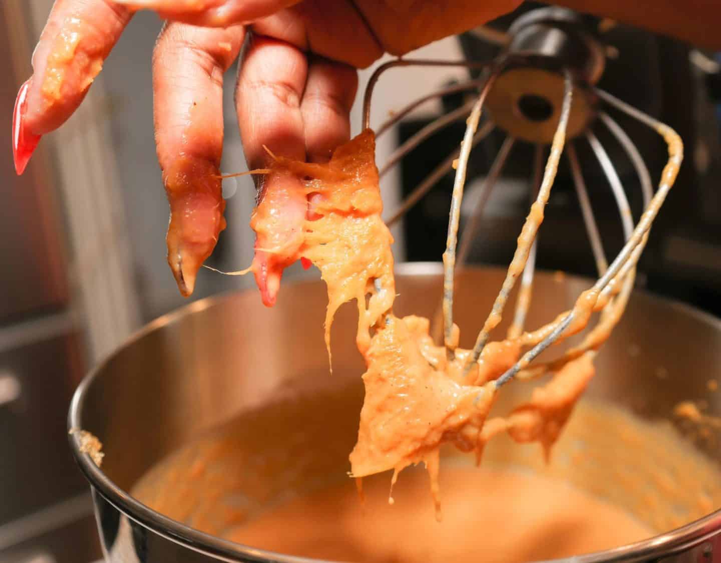Sweet potato strings collected on a stand mixer whisk while Shaunda Necole prepares smooth sweet potato pie filling for The Soul Food Pot®.