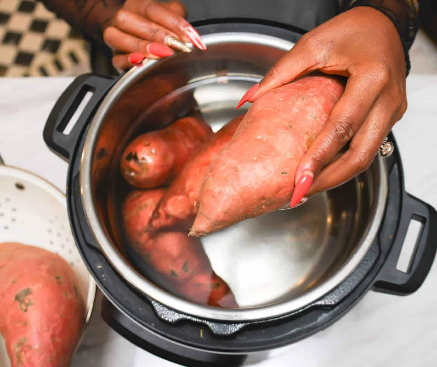 Whole sweet potatoes placed in an Instant Pot for pressure cooking before making The Soul Food Pot® Black folks’ sweet potato pie filling.