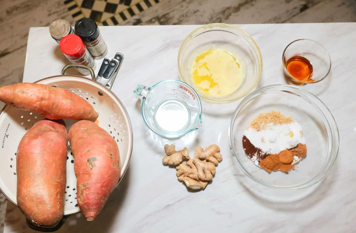 The Soul Food Pot candied yams ingredients: Sweet potatoes, melted butter, brown and granulated sugar, warm spices, ginger, maple syrup, vanilla, and water for soul food candied yams.