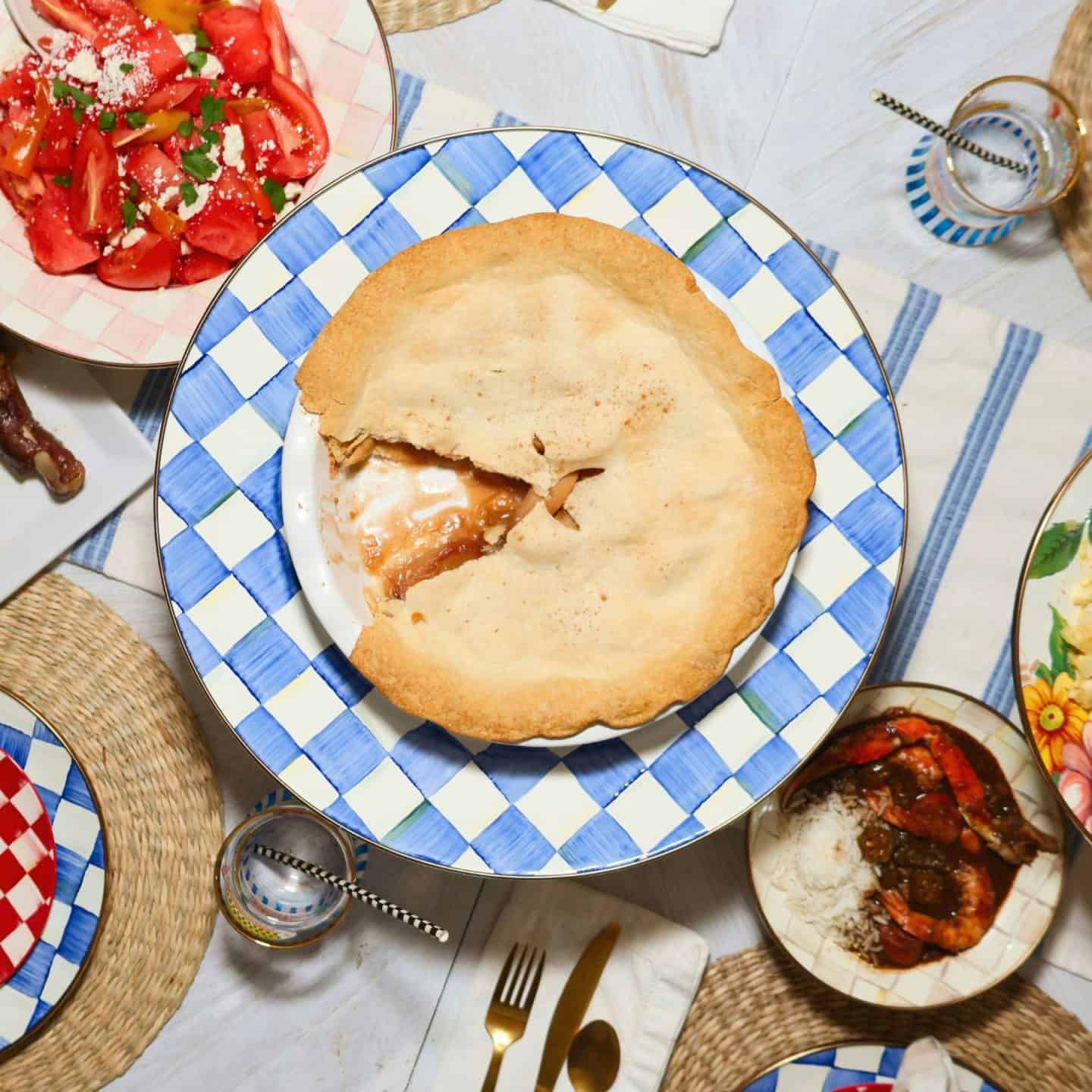 Apple pie served at a family-style dinner table with Southern dishes, showing The Soul Food Pot® apple pie as a dessert for gatherings and Sunday dinner.
