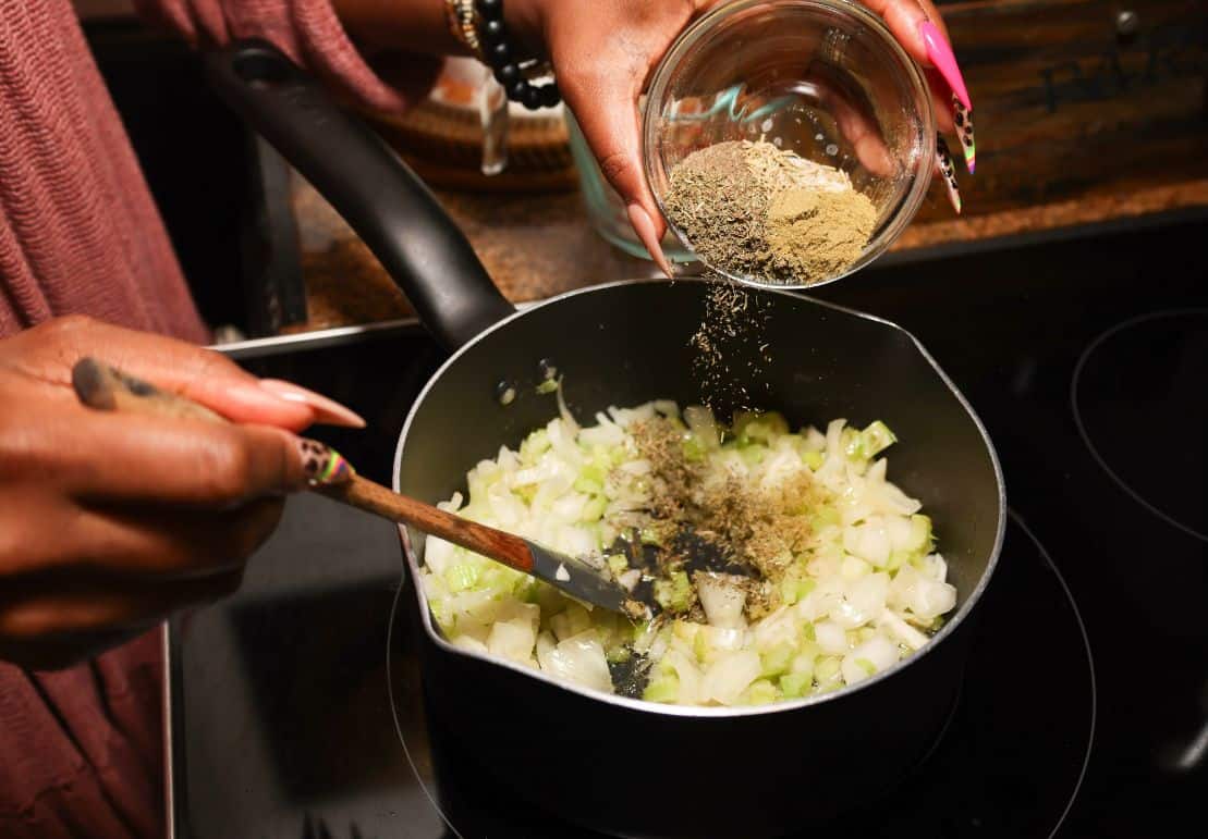 Onion and celery sautéing with thyme, rosemary, and sage for The Soul Food Pot® Black folks chicken and dressing.