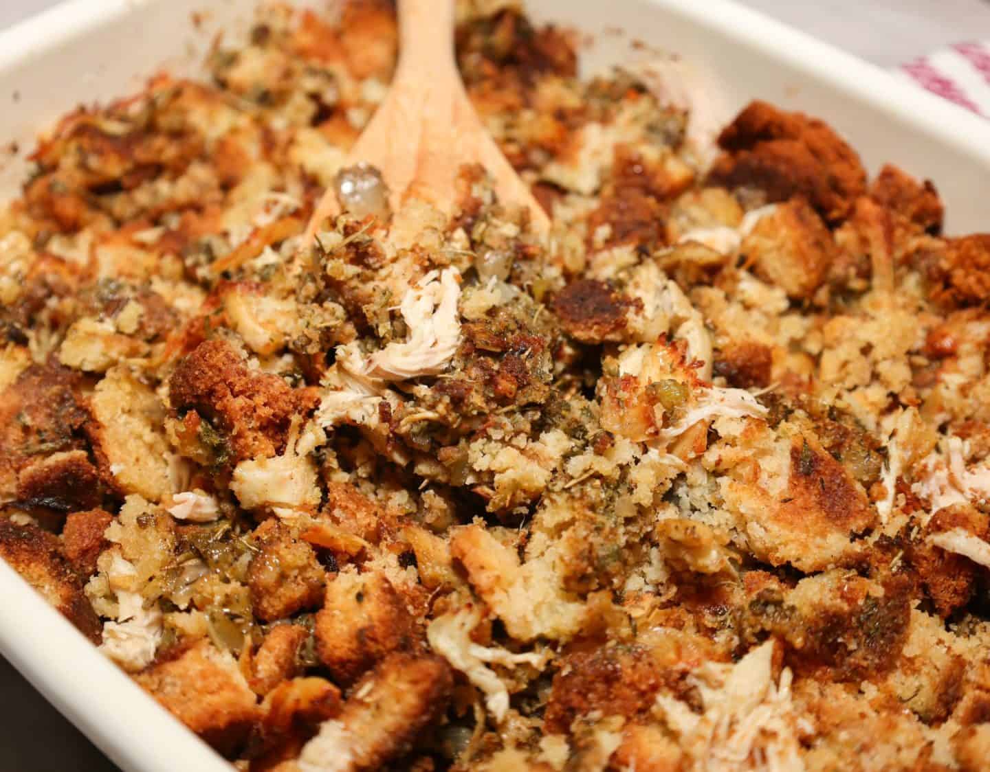 Close-up of moist Black folks chicken and dressing with golden cornbread pieces, shredded chicken, onion, celery, and savory herbs, from The Soul Food Pot®.