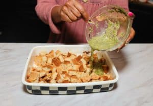 egg mixture being added to cubed cornbread for dressing