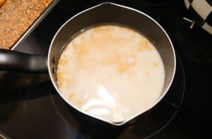 macaroni cooking in a mixture of milk and water