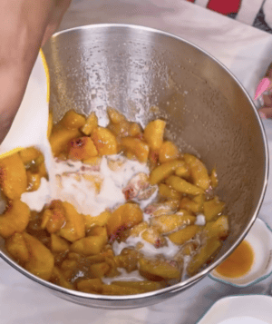 Cornstarch mixture being added to the peaches