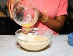 Melted butter being added to yellow cornmeal