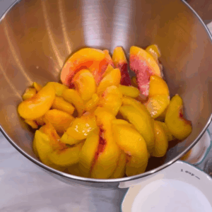Sliced peaches in mixing bowl