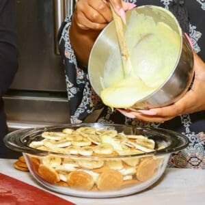 Spread a layer of the cream cheese-whipped topping mixture over the pudding.