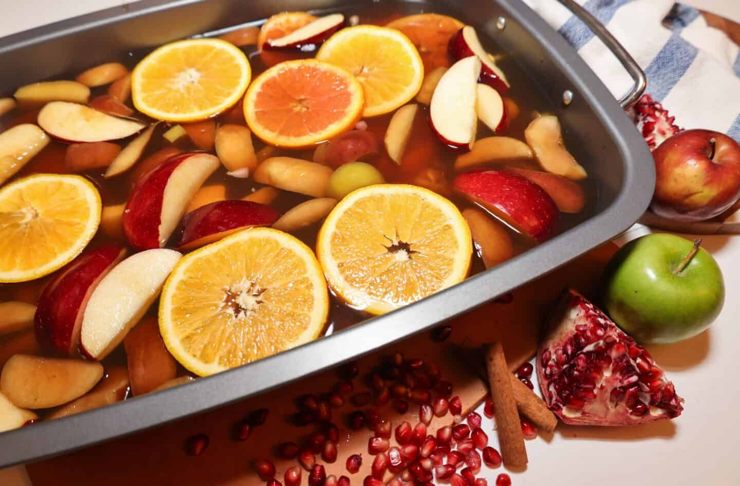 The Soul Food Pot® apple cider-inspired turkey roasting base with apples, oranges, pomegranate, cinnamon, and warm spices ready for the roasting pan.
