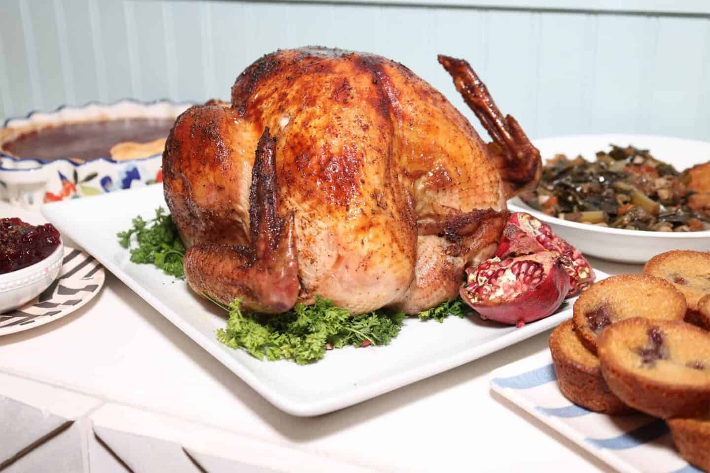 Black folks’ Southern turkey served as the centerpiece of a soul food holiday table with collard greens, cornbread, cranberry sauce, and other Southern sides.
