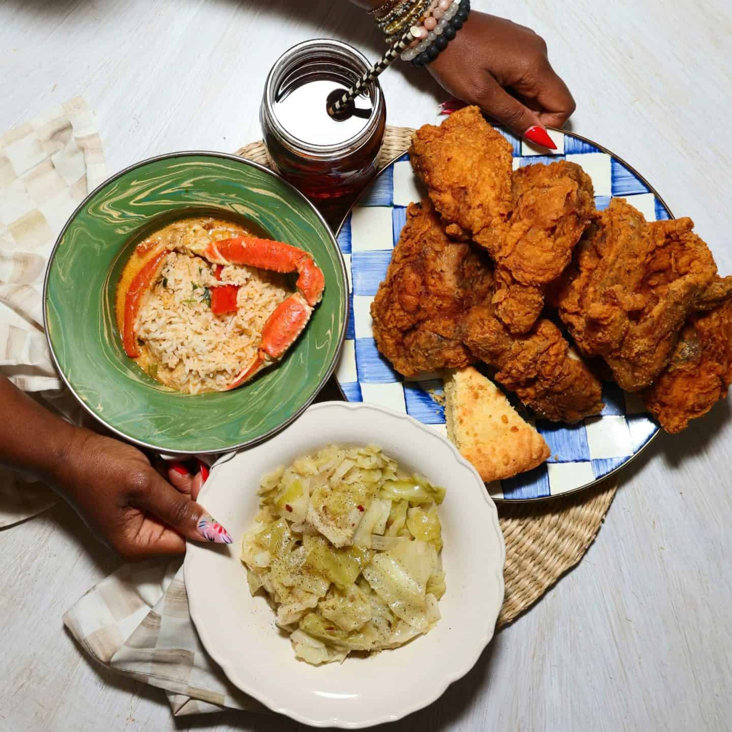 Black folks’ soul food cabbage served with Southern fried chicken, sweet tea, cornbread, and gumbo with rice for a soul food dinner — serving inspiration from The Soul Food Pot®.